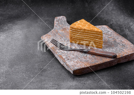 Delicious fresh sweet honey cake layer cake with white cream 104502198