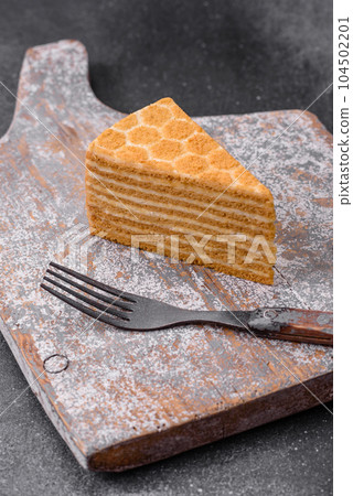 Delicious fresh sweet honey cake layer cake with white cream 104502201