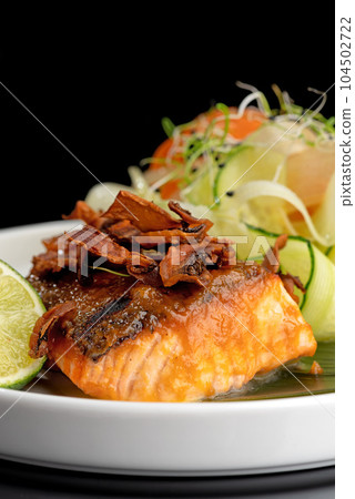 fresh perch fish fillet and herbs on a black background with reflection. 104502722