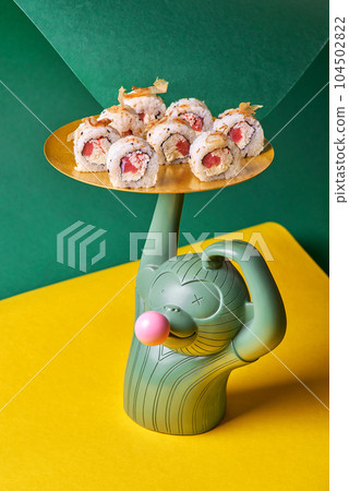 Sushi roll with tuna, shrimp, salmon, smoked eel, avocado, philadelphia cheese on a yellow background. 104502822