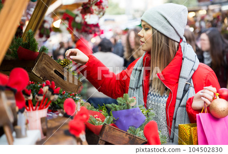 Girl shopping Christmas decorations 104502830