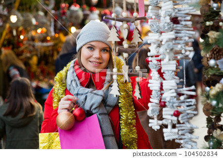 Portrait of young girl choosing xmas gifts on the street market Portrait of young girl choosing xmas gifts on the street market 104502834