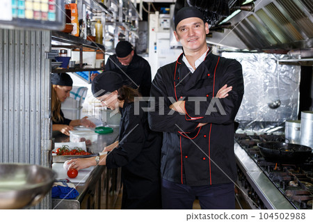 Friendly cooks in process of cooking dishes 104502988