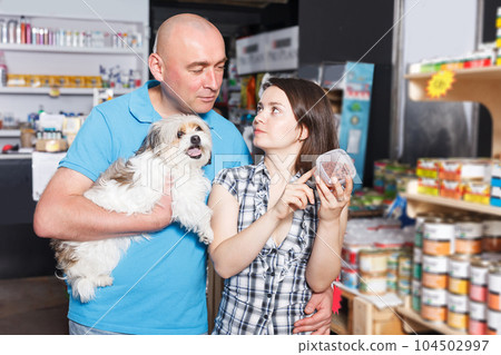couple with small dog choosing preserves couple with small dog choosing preserves 104502997