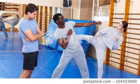 People fighting with coach at gym People fighting with coach at gym 104503000