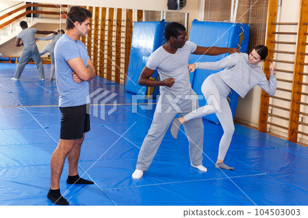 People fighting with coach at gym People fighting with coach at gym 104503003