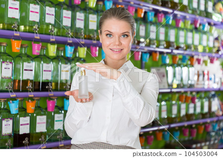 Female seller showing perfume Female seller showing perfume 104503004