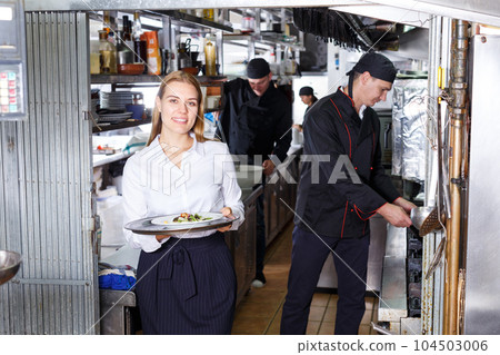Portrait of waitress at restaurant kitchen Portrait of waitress at restaurant kitchen 104503006