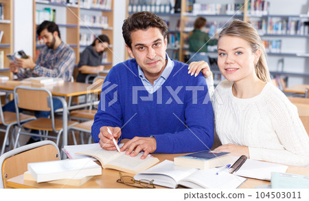 Young people preparing for exam in library Young people preparing for exam in library 104503011