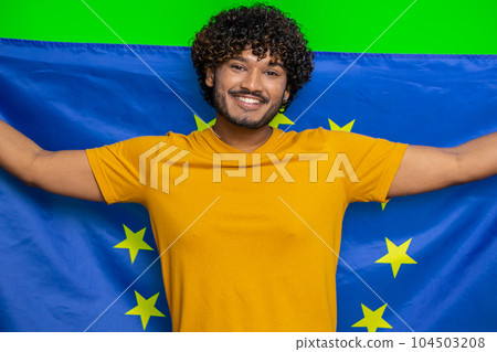 Happy young indian man waving European Union flag, smiling, cheering democratic laws, human rights 104503208