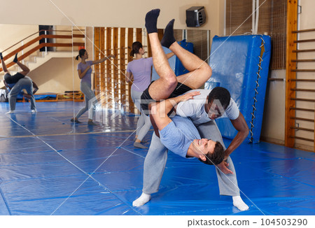 Two men practicing self defense techniques 104503290