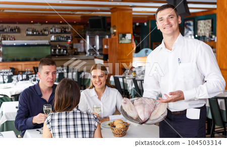 Waiter showing tray of fish Waiter showing tray of fish 104503314