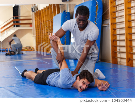 Two men practicing self defense techniques Two men practicing self defense techniques 104503444