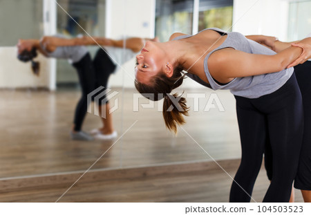females doing stretching workout in pairs females doing stretching workout in pairs 104503523