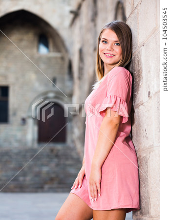 City portrait of woman near old wall 104503545