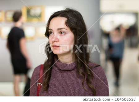 Woman visiting museum and thinking indoors Woman visiting museum and thinking indoors 104503553