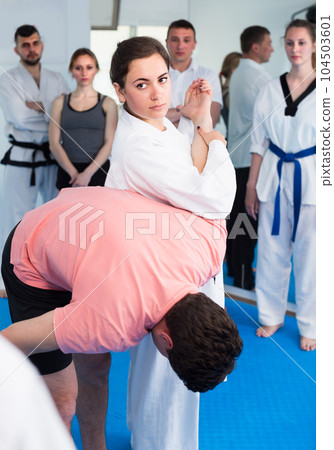 Female instructor is showing new submission hold to adults Female instructor is showing new submission hold to adults 104503601