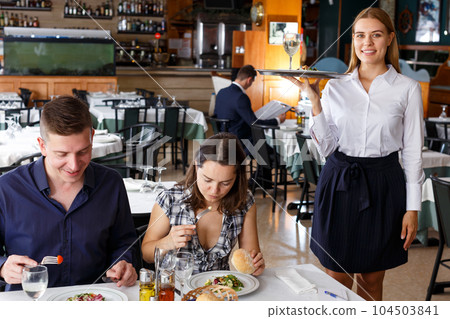 Waitress in white shirt holding tray Waitress in white shirt holding tray 104503841