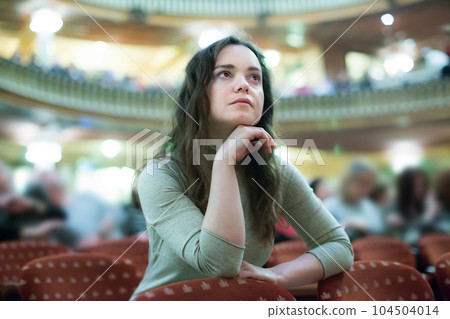 Adult woman theatre goer looking at play 104504014