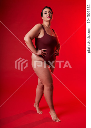 Vertical view of the gorgeous asian woman feeling proud in her natural body while standing Vertical view of the gorgeous asian woman feeling proud in her natural body while standing 104504881
