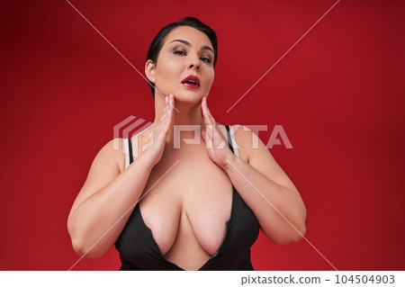 Fat sexy woman in underwear on red studio background Fat sexy woman in underwear on red studio background 104504903