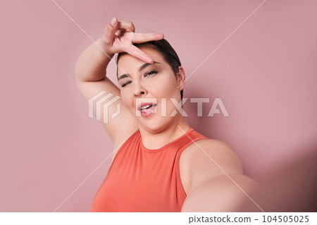 Attractive overweight female having delightful look smiling broadly 104505025