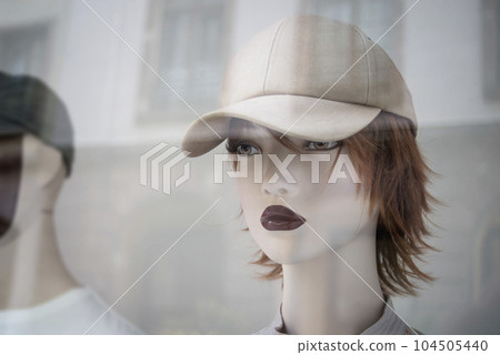 Closeup of summer base ball hat on the head of mannequin in a fashion store showroom Closeup of summer base ball hat on the head of mannequin in a fashion store showroom 104505440