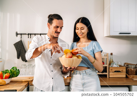 Healthy lovers cooking food in kitchen, Couple spending time together 104505702