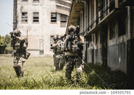Smart teamwork of soldiers running forward and attacking enemy Smart teamwork of soldiers running forward and attacking enemy 104505791