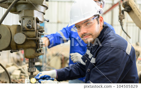 Smiling portrait of confident engineer worker at factory Smiling portrait of confident engineer worker at factory 104505829