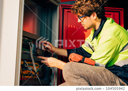 Technician engineer holding robot controller checking and repairing machine 104505942