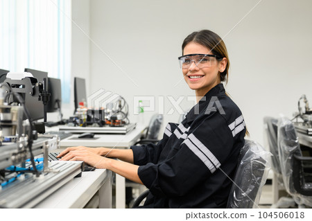 Portrait of female engineer technician working with robot maintenance 104506018