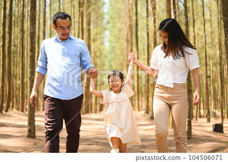 Happy family travel in pine forest park together on weekend 104506071