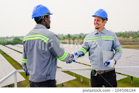 Happy maintenance engineer checking and maintaining solar panels Happy maintenance engineer checking and maintaining solar panels 104506184