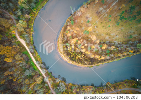 Above aerial shot of green pine forests and yellow foliage groves with beautiful texture of golden treetops. Beautiful fall season scenery in evening. Mountains in autumn colors in golden time 104506208