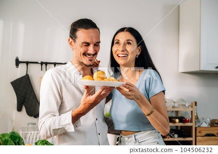 Healthy lovers cooking food in kitchen, Couple spending time together Healthy lovers cooking food in kitchen, Couple spending time together 104506232
