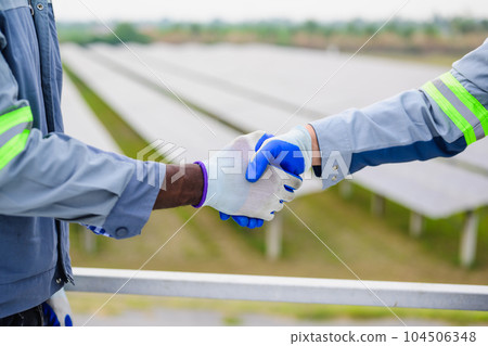 Happy maintenance engineer checking and maintaining solar panels 104506348