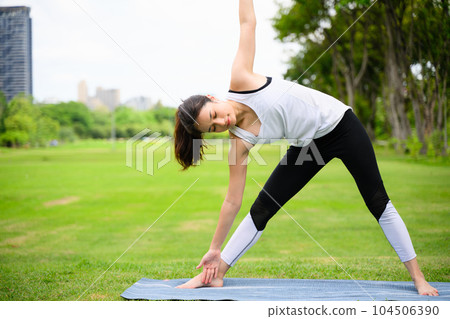 Healthy young woman enjoying and relaxing yoga outdoor in green park Healthy young woman enjoying and relaxing yoga outdoor in green park 104506390