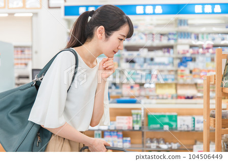 A woman shopping at a pharmacy, drug store, or convenience store 104506449