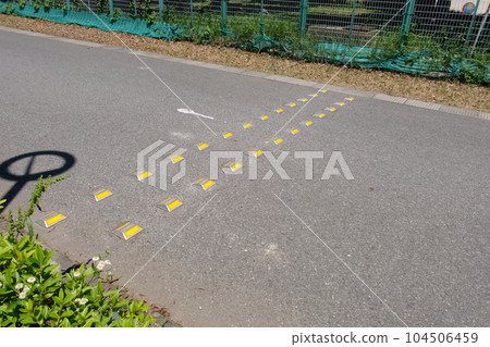 Road hump and cat's eye 104506459