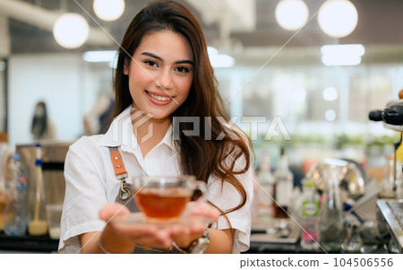 Smiling portrait of young barista business owner at retail coffee shop 104506556