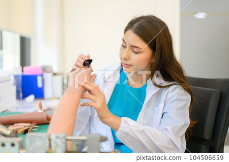 Technician making prosthetic limb device at laboratory 104506659