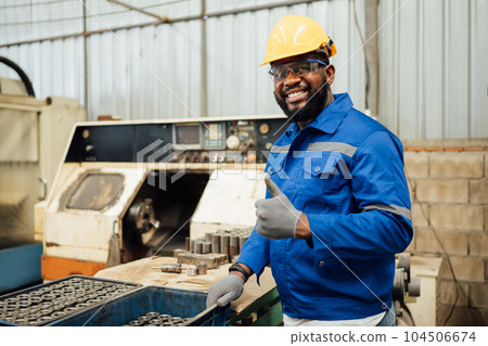 Smiling portrait of confident engineer worker at factory 104506674