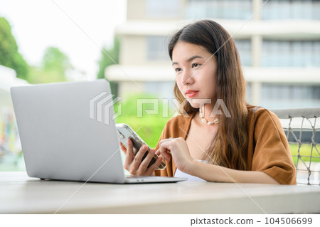 Smiling portrait of businesswoman working outdoor office 104506699