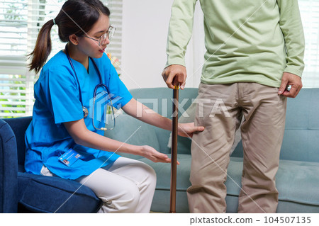 Doctor examining senior patient at home visit 104507135