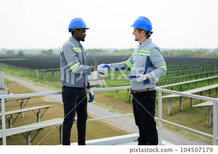 Maintenance engineers working with teamwork at ecological solar farm 104507179
