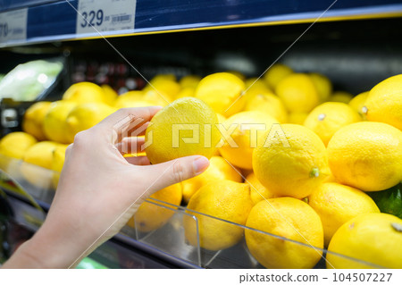 Young adult woman using phone in grocery store 104507227