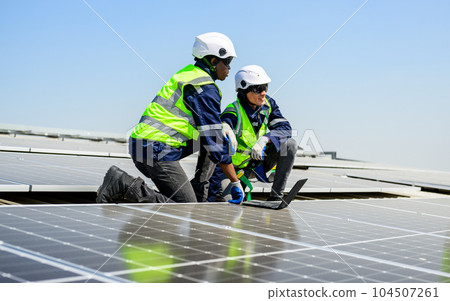 Professional engineer technician with safety helmet checking solar system 104507261