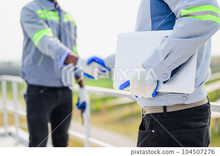 Maintenance technician working on ecological solar cell farm 104507276