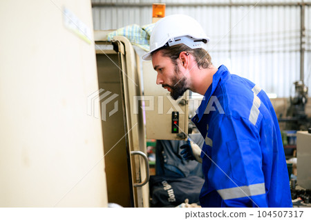 Engineer technician controlling robotic arms on computer laptop 104507317